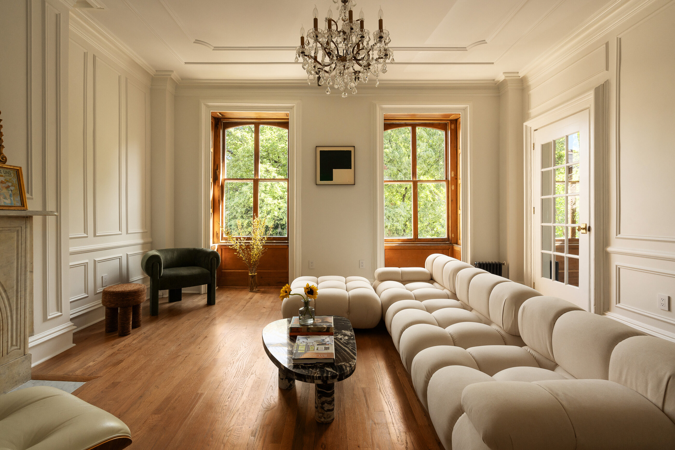 The living room of 428 West 20th Street, 2nd floor — a sunlit Chelsea living room with original fireplace, tall windows, and wide-plank floors