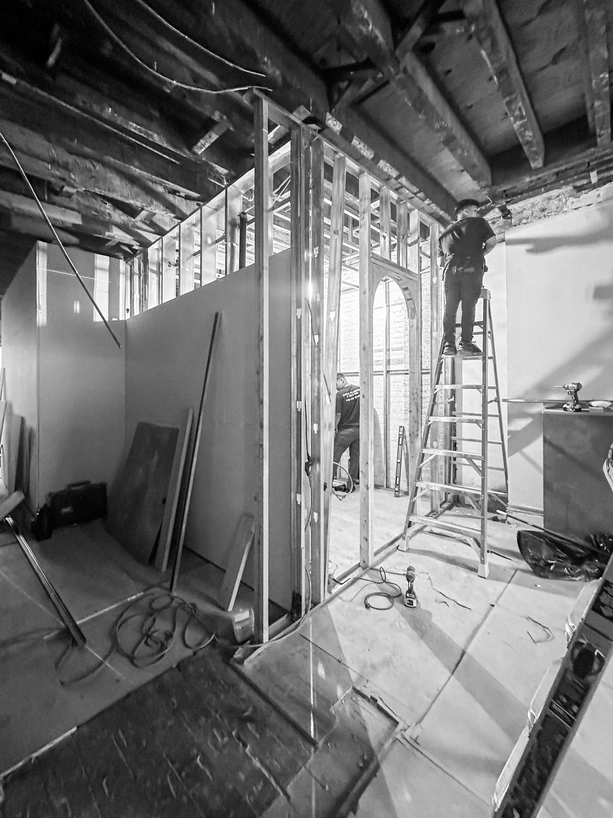 Mid-renovation interior at № 428 West 20th Street — framed-out walls and exposed brick