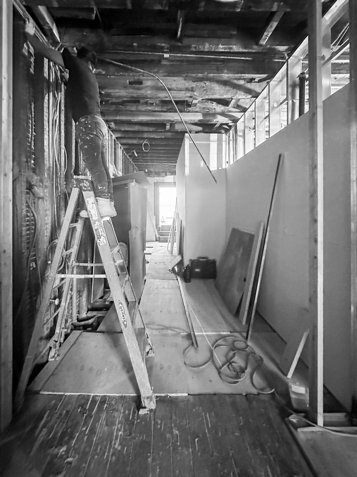 Mid-renovation hallway at № 428 West 20th Street — exposed joists and original floors